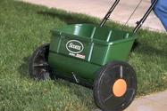 A drop spreader for applying fertilizer.